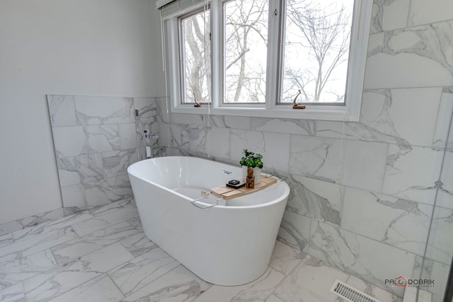 bathroom with a tub to relax in