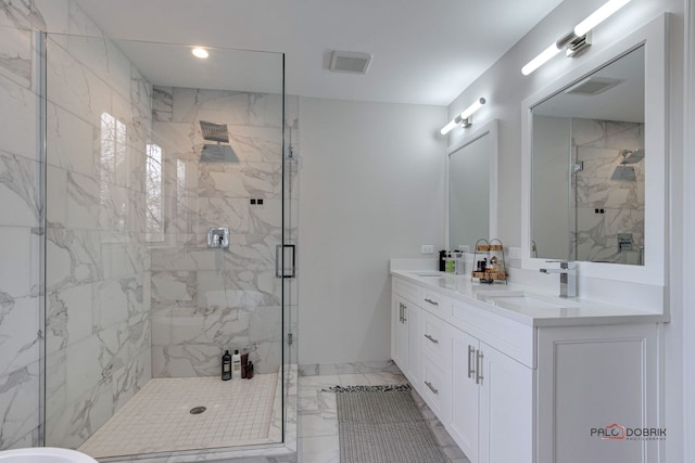 bathroom with a shower with door and vanity