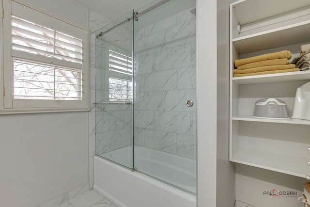 bathroom featuring combined bath / shower with glass door