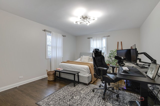 bedroom with dark hardwood / wood-style flooring