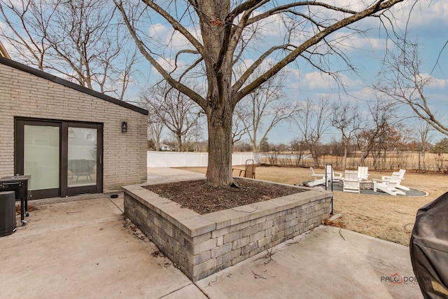 view of patio / terrace featuring an outdoor fire pit