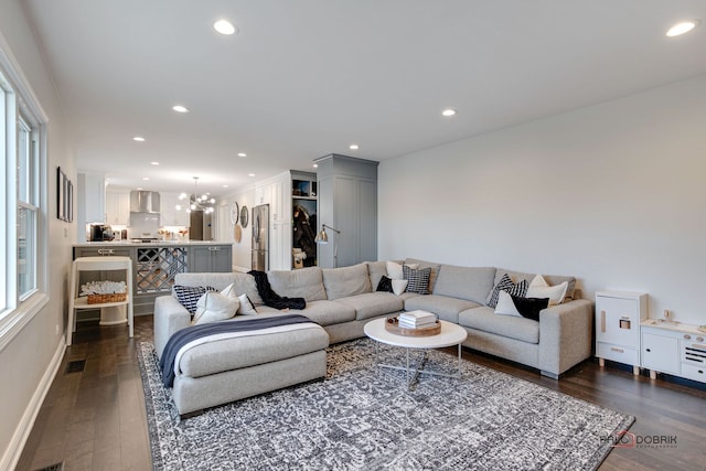 living room featuring dark hardwood / wood-style floors and a notable chandelier