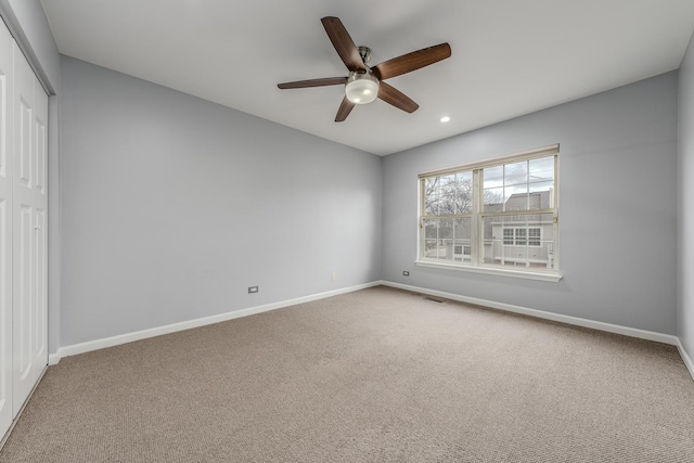 unfurnished bedroom featuring carpet flooring, ceiling fan, and a closet