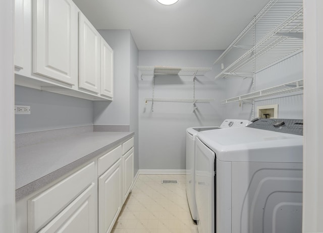 laundry room featuring cabinets and washing machine and clothes dryer