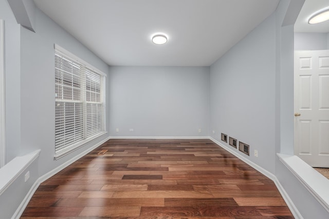 spare room featuring dark wood-type flooring