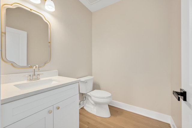 bathroom featuring vanity, toilet, and hardwood / wood-style floors