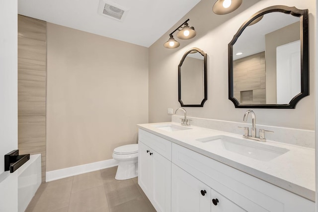 bathroom featuring vanity, tile patterned floors, and toilet