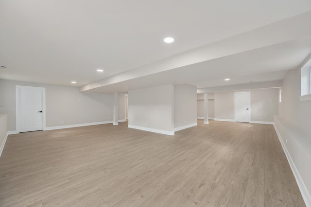 basement with light hardwood / wood-style floors