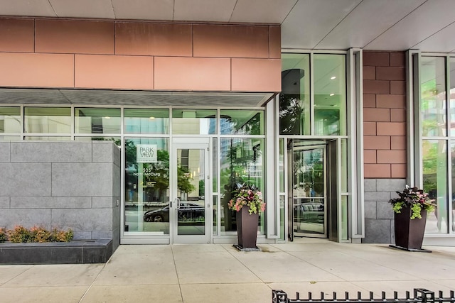 doorway to property featuring concrete block siding