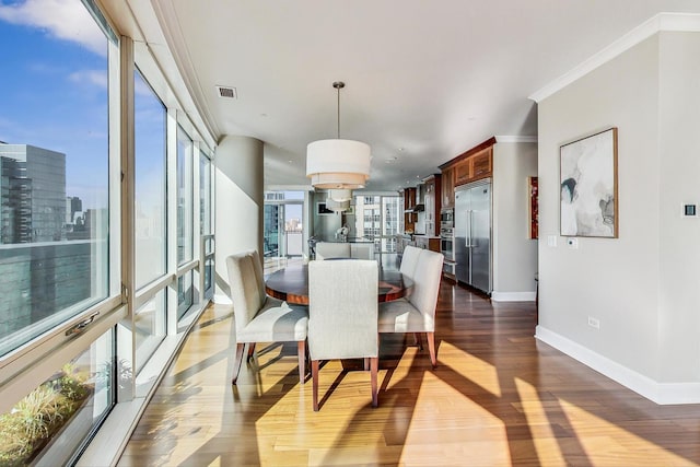 dining space featuring dark wood-style flooring, floor to ceiling windows, visible vents, ornamental molding, and baseboards