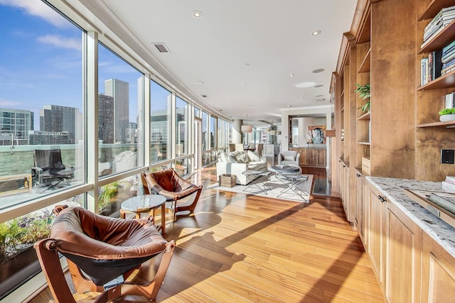 sunroom featuring a city view and visible vents