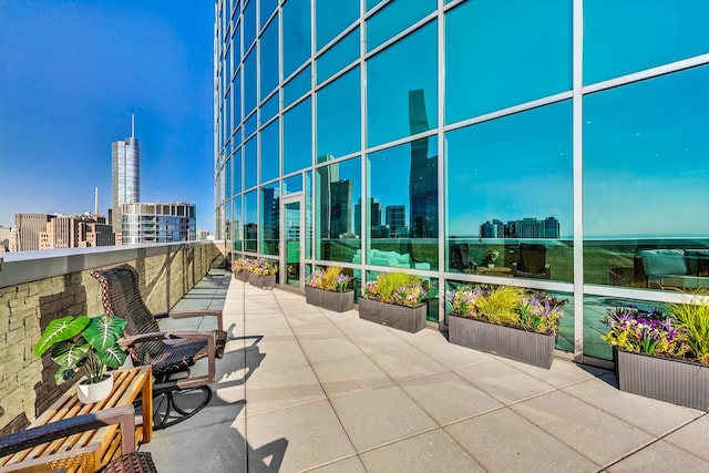 view of patio with a balcony and a city view