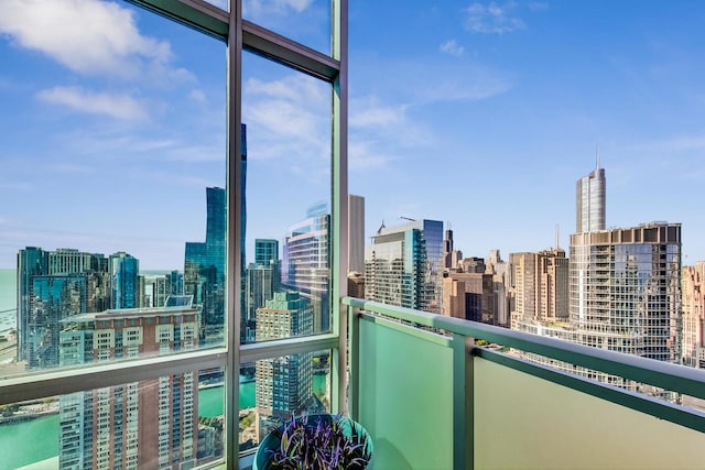 balcony with a water view and a city view