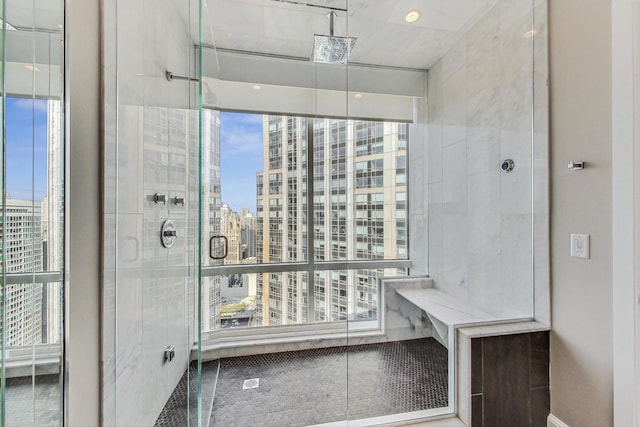 bathroom with a stall shower, a wealth of natural light, and a city view