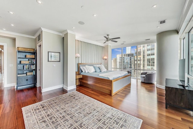 bedroom featuring recessed lighting, visible vents, baseboards, wood-type flooring, and crown molding