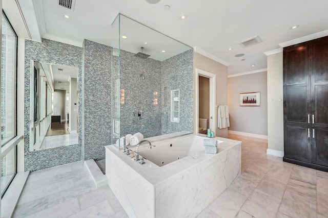 bathroom featuring baseboards, marble finish floor, ornamental molding, a jetted tub, and a stall shower