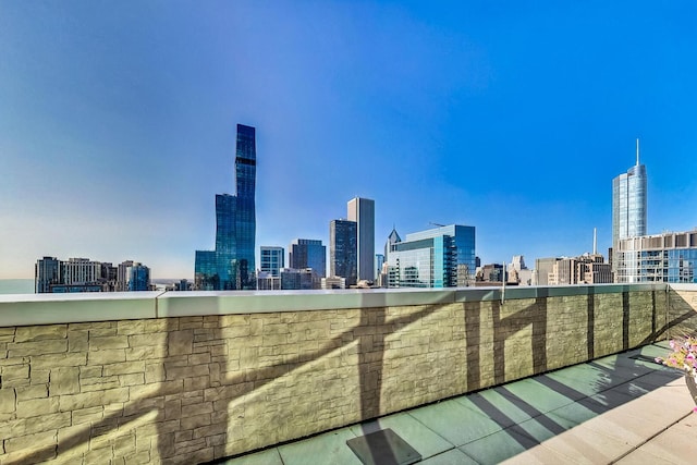 view of patio featuring a balcony and a view of city