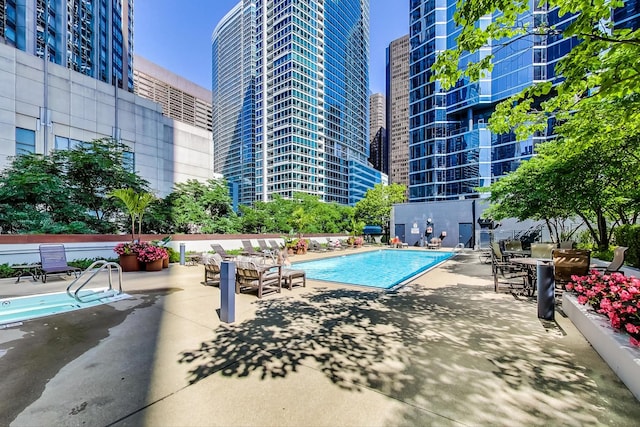 community pool featuring a city view and a patio