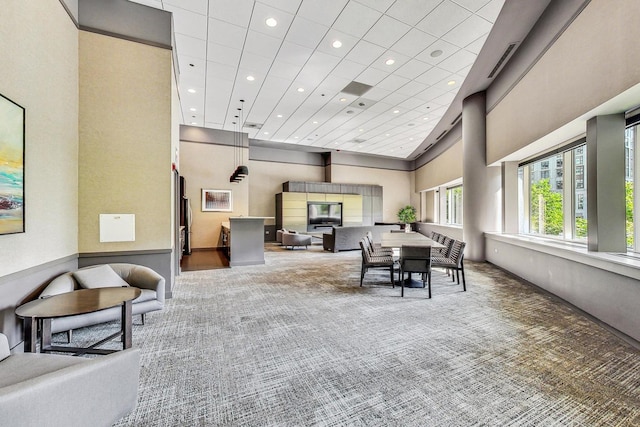 dining space featuring carpet, a towering ceiling, and recessed lighting