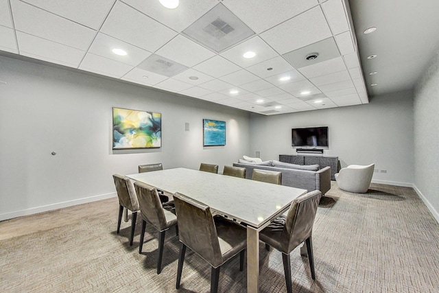 dining room with a paneled ceiling, recessed lighting, light colored carpet, visible vents, and baseboards