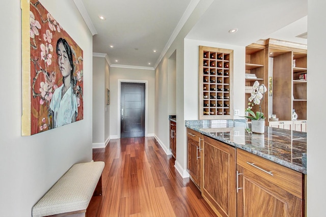 bar with crown molding, baseboards, wood finished floors, and recessed lighting