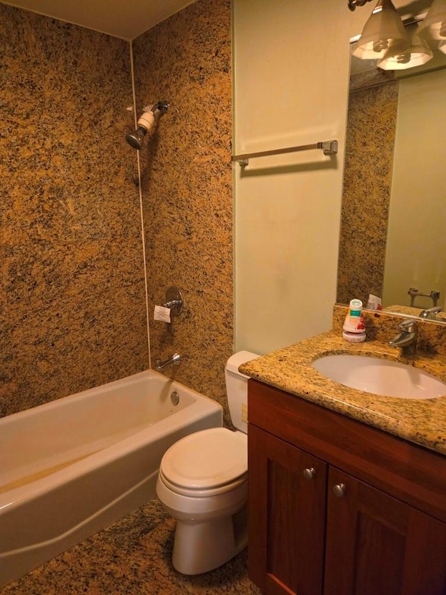 full bathroom featuring vanity, tiled shower / bath, and toilet