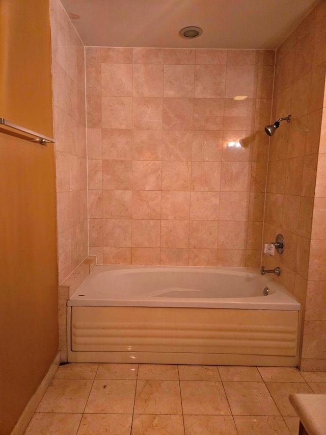 bathroom with tiled shower / bath and tile patterned flooring