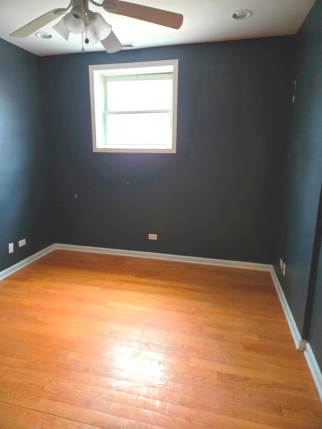 spare room featuring light hardwood / wood-style flooring and ceiling fan