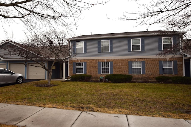 view of front of property featuring a garage and a front lawn