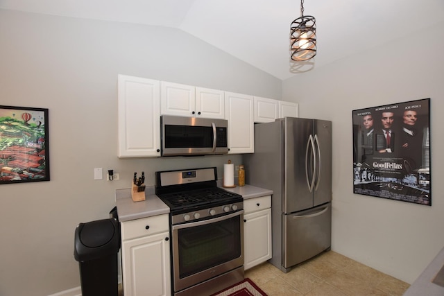 kitchen featuring white cabinetry, hanging light fixtures, stainless steel appliances, and lofted ceiling