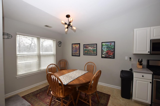 tiled dining space with a notable chandelier