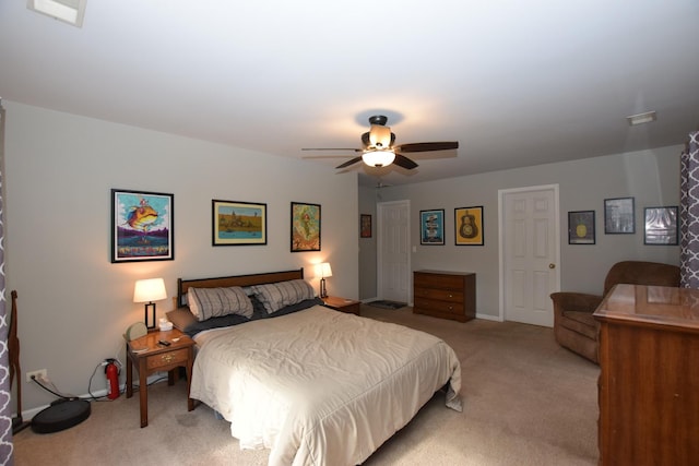 bedroom with ceiling fan and light carpet