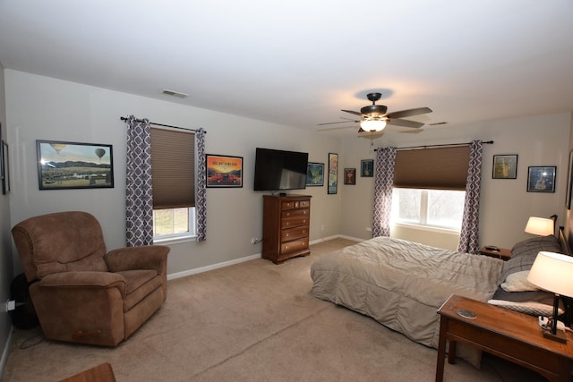 bedroom featuring light colored carpet and ceiling fan