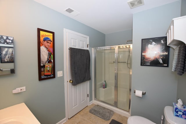 bathroom featuring vanity, tile patterned floors, a shower with door, and toilet