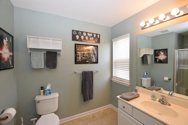 bathroom featuring tile patterned flooring, vanity, a shower, and toilet