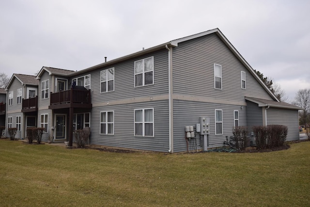 rear view of property featuring a lawn