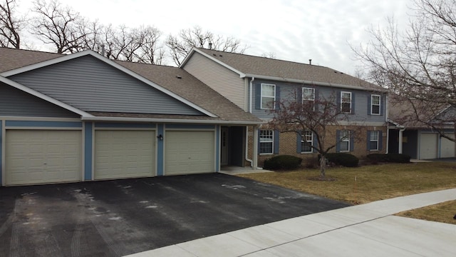 colonial home featuring a garage and a front yard