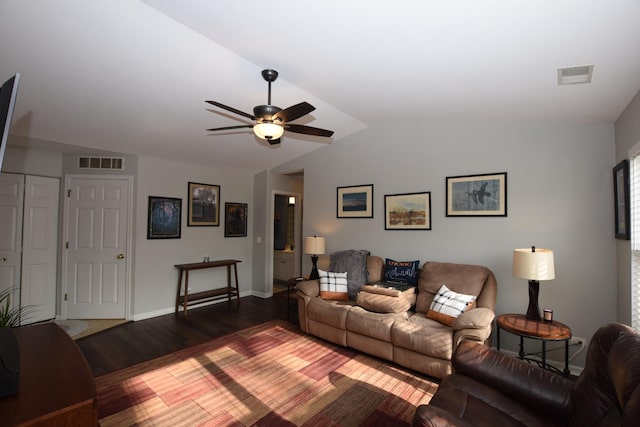 living room featuring ceiling fan, dark hardwood / wood-style floors, and vaulted ceiling