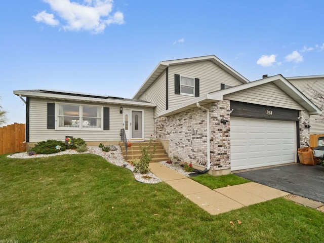 tri-level home with a garage and a front yard