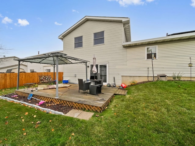 rear view of house with a wooden deck, a pergola, a lawn, and a gazebo