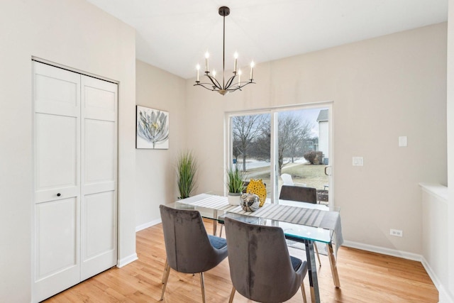 dining space featuring a notable chandelier and light hardwood / wood-style floors