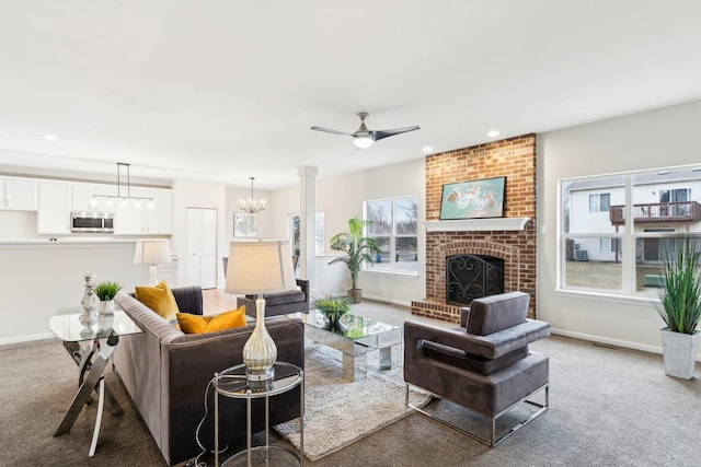 living room with a fireplace, a wealth of natural light, and carpet flooring