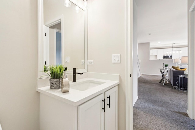 bathroom with vanity and a notable chandelier