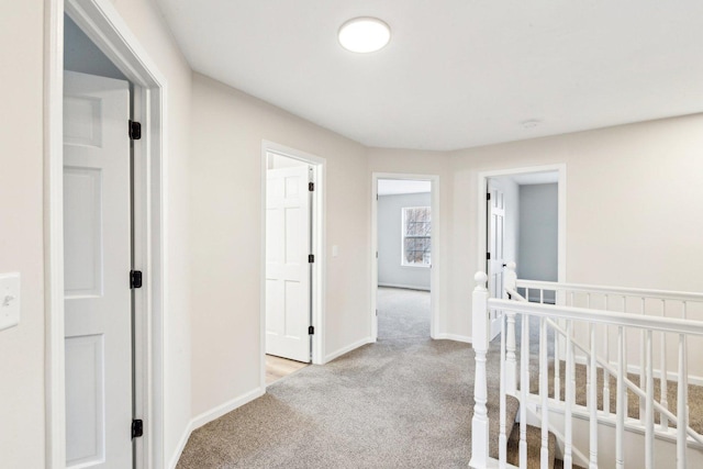 hallway with light colored carpet