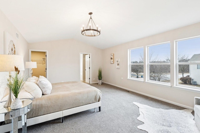 carpeted bedroom with vaulted ceiling and an inviting chandelier