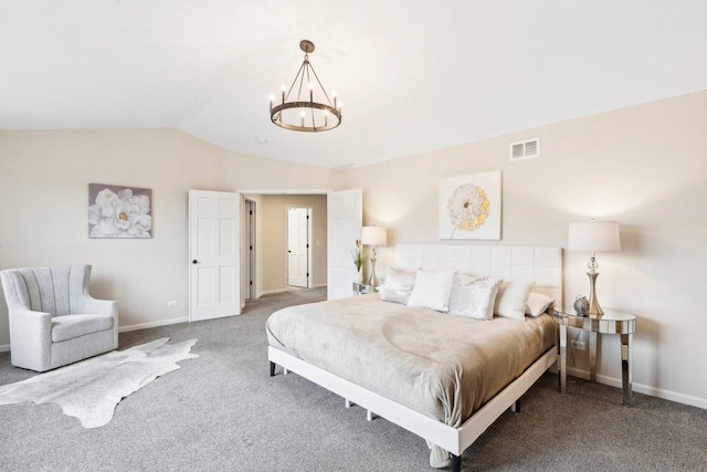 carpeted bedroom featuring an inviting chandelier and vaulted ceiling