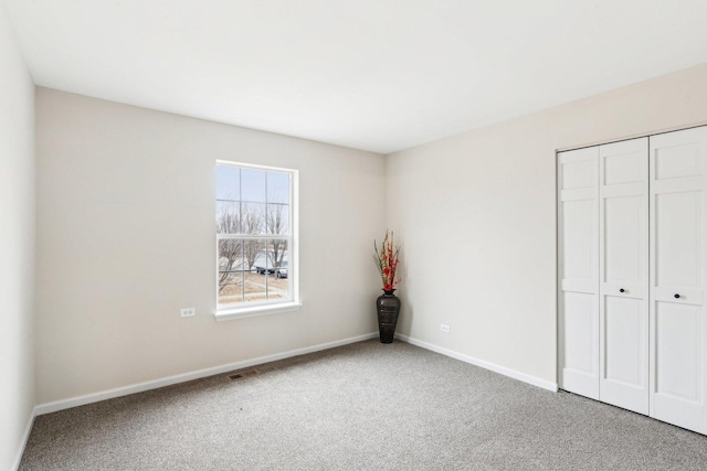 unfurnished bedroom featuring a closet and carpet flooring