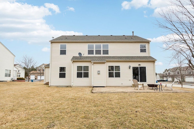 rear view of property featuring a yard and a patio area