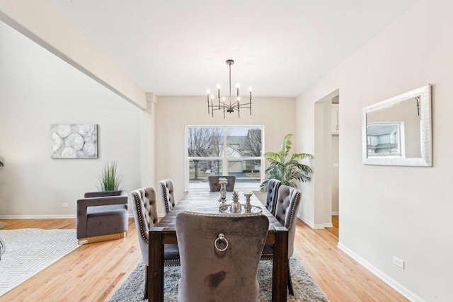 dining area featuring a chandelier and light hardwood / wood-style floors