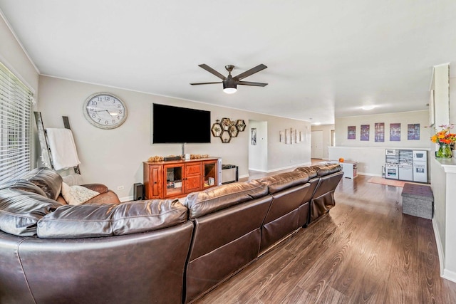 living room featuring dark wood-type flooring and ceiling fan